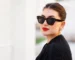 Portrait de profil d'une femme élégante portant des lunettes de soleil Ray-Ban tendance en acétate écaille de tortue foncé avec verres noirs chez Optical Gallery.