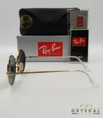 Lunettes de soleil de luxe Ray-Ban Oval RB1970 dorées avec verres foncés, étui en cuir et packaging d'origine - Optical Gallery.