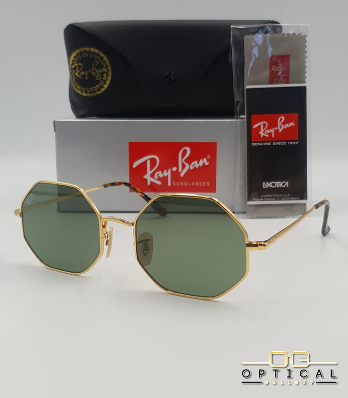 ray-ban-octagonal-rb1972-metal-or-maroc Lunettes de soleil octogonales Ray-Ban RB1972 avec monture fine en métal doré, verres verts et manchons écaillés, présentées avec leur étui noir - Optical Gallery.