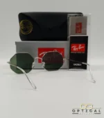 Lunettes de soleil géométriques octogonales Ray-Ban RB1972 dorées avec verres verts, présentées avec leur étui en cuir marron et le logo Optical Gallery.