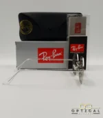 Lunettes de soleil géométriques octogonales Ray-Ban RB1972 dorées avec verres verts, présentées avec leur étui en cuir marron et le logo Optical Gallery.