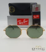 Lunettes de soleil octogonales Ray-Ban RB1972 avec monture fine en métal doré, verres verts et manchons écaillés, présentées avec leur étui noir - Optical Gallery.