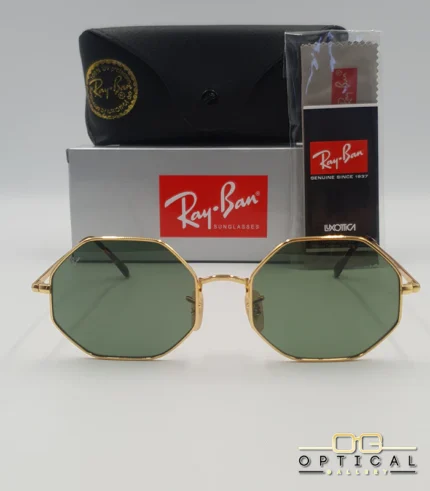 Lunettes de soleil octogonales Ray-Ban RB1972 avec monture fine en métal doré, verres verts et manchons écaillés, présentées avec leur étui noir - Optical Gallery.