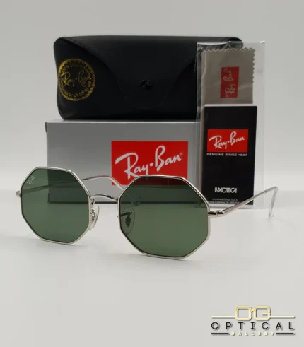 Lunettes de soleil géométriques octogonales Ray-Ban RB1972 dorées avec verres verts, présentées avec leur étui en cuir marron et le logo Optical Gallery.