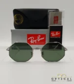 Lunettes de soleil géométriques octogonales Ray-Ban RB1972 dorées avec verres verts, présentées avec leur étui en cuir marron et le logo Optical Gallery.