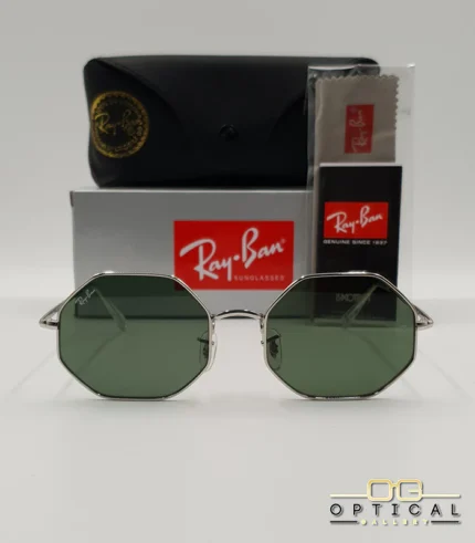 Lunettes de soleil géométriques octogonales Ray-Ban RB1972 dorées avec verres verts, présentées avec leur étui en cuir marron et le logo Optical Gallery.