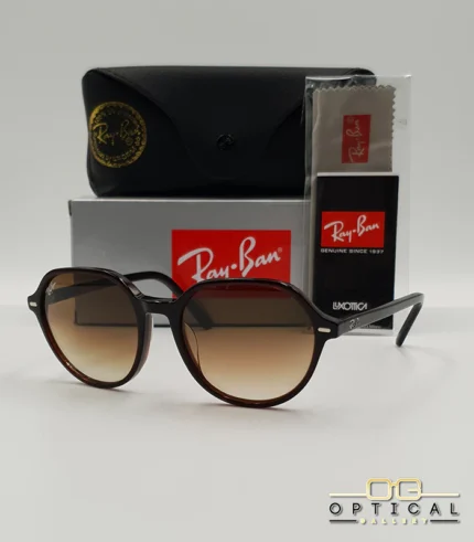 Lunettes de soleil Ray-Ban Thalia RB2195 avec monture fine en acétate écaille de tortue et verres teintés, présentées avec leur étui noir - Optical Gallery.