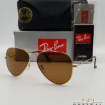 Lunettes de soleil Ray-Ban Aviator RB3025 monture métallique dorée avec verres marrons classiques B-15, étui et boîte d'origine.