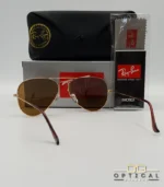 Lunettes de soleil Ray-Ban Aviator RB3025 monture métallique dorée avec verres marrons classiques B-15, étui et boîte d'origine.