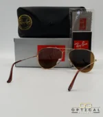 Lunettes de soleil Ray-Ban Aviator RB3025 monture métallique dorée avec verres marrons classiques B-15, étui et boîte d'origine.