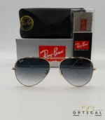 Lunettes de soleil Ray-Ban Aviator RB3025 monture métallique dorée avec verres dégradés gris-bleu, étui et boîte d'origine.