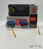 Lunettes de soleil Ray-Ban Aviator RB3025 monture métallique dorée avec verres dégradés bleus, étui et boîte d'origine.