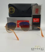 Lunettes de soleil Ray-Ban Aviator RB3025 monture métallique or rose avec verres dégradés marrons, étui et boîte d'origine.