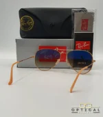 Lunettes de soleil Ray-Ban Aviator RB3025 monture métallique or rose avec verres dégradés marrons, étui et boîte d'origine.