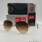 Lunettes de soleil Ray-Ban Aviator RB3025 monture métallique dorée avec verres dégradés marrons, étui et boîte d'origine.