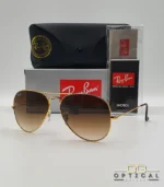 Lunettes de soleil Ray-Ban Aviator RB3025 monture métallique dorée avec verres dégradés marrons, étui et boîte d'origine.