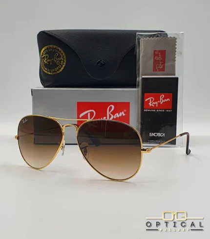 Lunettes de soleil Ray-Ban Aviator RB3025 monture métallique dorée avec verres dégradés marrons, étui et boîte d'origine.