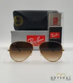 Lunettes de soleil Ray-Ban Aviator RB3025 monture métallique dorée avec verres dégradés marrons, étui et boîte d'origine.