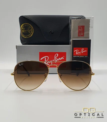 Lunettes de soleil Ray-Ban Aviator RB3025 monture métallique dorée avec verres dégradés marrons, étui et boîte d'origine.