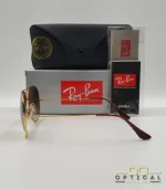 Lunettes de soleil Ray-Ban Aviator RB3025 monture métallique dorée avec verres dégradés marrons, étui et boîte d'origine.