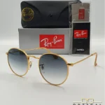 Lunettes de soleil Ray-Ban Round Metal RB3447 monture métallique dorée avec verres dégradés bleus, étui et boîte d'origine.