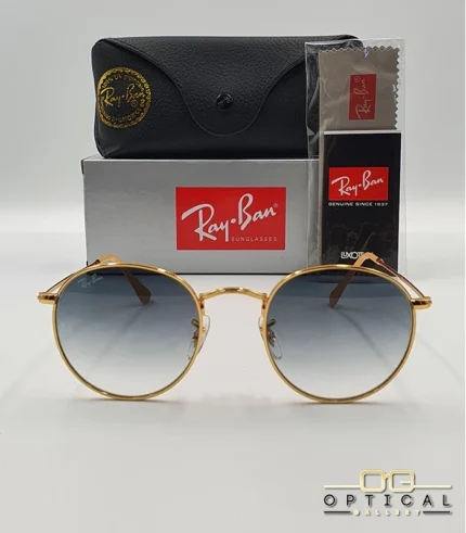 Lunettes de soleil Ray-Ban Round Metal RB3447 monture métallique dorée avec verres dégradés bleus, étui et boîte d'origine.