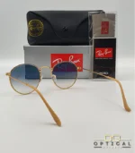 Lunettes de soleil Ray-Ban Round Metal RB3447 monture métallique dorée avec verres dégradés bleus, étui et boîte d'origine.