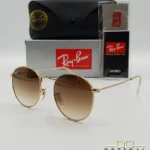 Lunettes de soleil Ray-Ban Round Metal RB3447 monture métallique dorée avec verres dégradés marrons, étui et boîte d'origine.