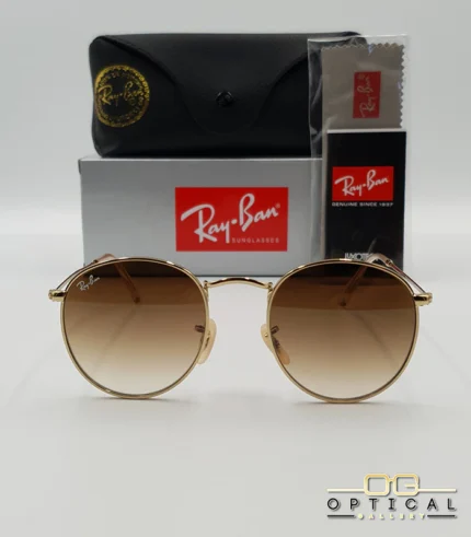 Lunettes de soleil Ray-Ban Round Metal RB3447 monture métallique dorée avec verres dégradés marrons, étui et boîte d'origine.