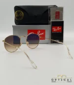 Lunettes de soleil Ray-Ban Round Metal RB3447 monture métallique dorée avec verres dégradés marrons, étui et boîte d'origine.
