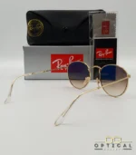 Lunettes de soleil Ray-Ban Round Metal RB3447 monture métallique dorée avec verres dégradés marrons, étui et boîte d'origine.