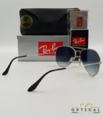 Lunettes de soleil Ray-Ban Aviator RB3025 monture métallique argentée avec verres dégradés bleus, étui et boîte d'origine.