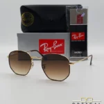 Lunettes de soleil Ray-Ban Hexagonal Flat Lenses RB3548N monture bicolore en métal doré et cerclage marron avec verres dégradés marrons, étui et boîte d'origine.