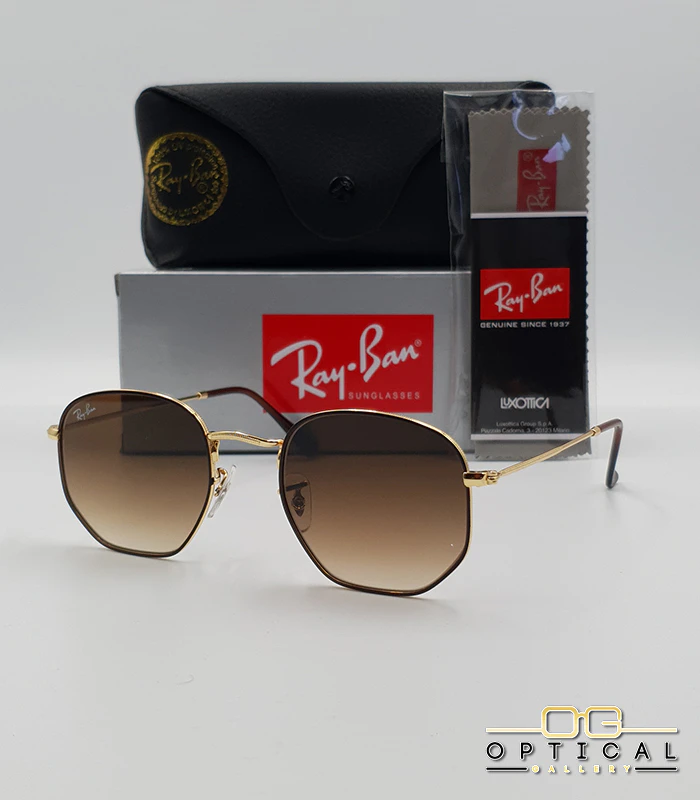 Lunettes de soleil Ray-Ban Hexagonal RB3548N - Doré et Marron / Marron Dégradé Lunettes de soleil Ray-Ban Hexagonal Flat Lenses RB3548N monture bicolore en métal doré et cerclage marron avec verres dégradés marrons, étui et boîte d'origine.