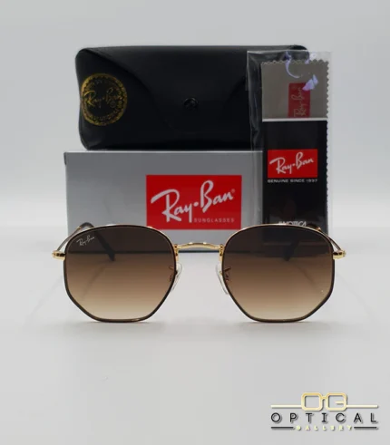 Lunettes de soleil Ray-Ban Hexagonal Flat Lenses RB3548N monture bicolore en métal doré et cerclage marron avec verres dégradés marrons, étui et boîte d'origine.