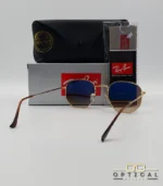 Lunettes de soleil Ray-Ban Hexagonal Flat Lenses RB3548N monture bicolore en métal doré et cerclage marron avec verres dégradés marrons, étui et boîte d'origine.