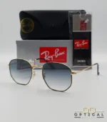 Lunettes de soleil Ray-Ban Hexagonal Flat Lenses RB3548N monture bicolore en métal doré et cerclage noir avec verres dégradés gris-bleu, étui et boîte d'origine.
