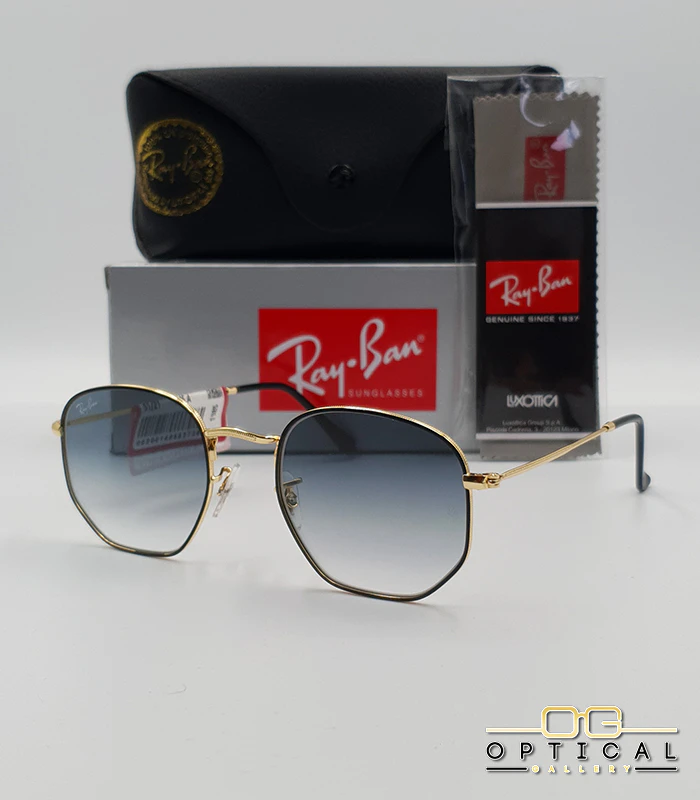 Lunettes de soleil Ray-Ban Hexagonal RB3548N - Doré et Noir / Gris Dégradé Lunettes de soleil Ray-Ban Hexagonal Flat Lenses RB3548N monture bicolore en métal doré et cerclage noir avec verres dégradés gris-bleu, étui et boîte d'origine.