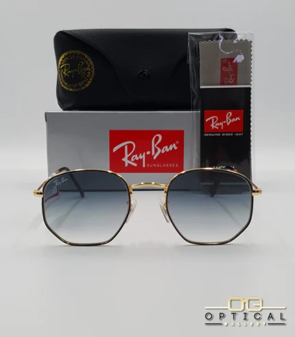 Lunettes de soleil Ray-Ban Hexagonal Flat Lenses RB3548N monture bicolore en métal doré et cerclage noir avec verres dégradés gris-bleu, étui et boîte d'origine.