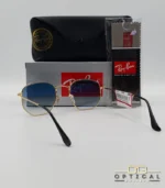 Lunettes de soleil Ray-Ban Hexagonal Flat Lenses RB3548N monture bicolore en métal doré et cerclage noir avec verres dégradés gris-bleu, étui et boîte d'origine.