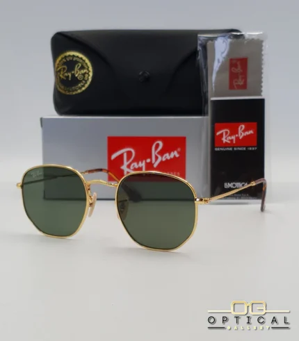 Lunettes de soleil Ray-Ban Hexagonal Flat Lenses RB3548N monture métallique dorée avec verres dégradés bleus, étui et boîte d'origine.
