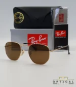 Lunettes de soleil Ray-Ban Hexagonal Flat Lenses RB3548N monture métallique dorée avec verres minéraux marrons classiques, étui et boîte d'origine.