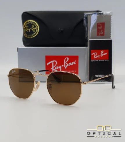 Lunettes de soleil Ray-Ban Hexagonal Flat Lenses RB3548N monture métallique dorée avec verres minéraux marrons classiques, étui et boîte d'origine.