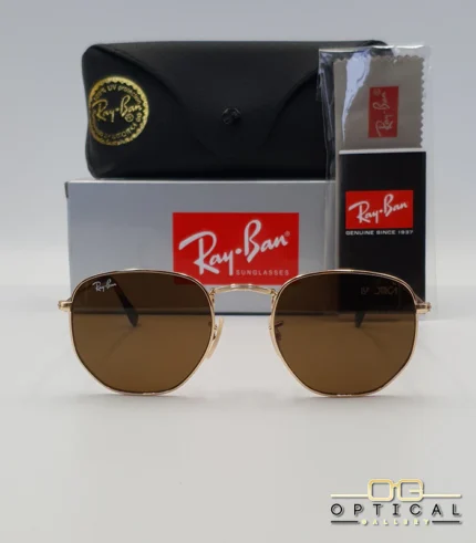 Lunettes de soleil Ray-Ban Hexagonal Flat Lenses RB3548N monture métallique dorée avec verres minéraux marrons classiques, étui et boîte d'origine.