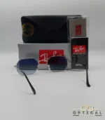 Lunettes de soleil Ray-Ban Octagonal RB3556 argentées avec verres dégradés gris, étui noir, boîte grise et accessoires.