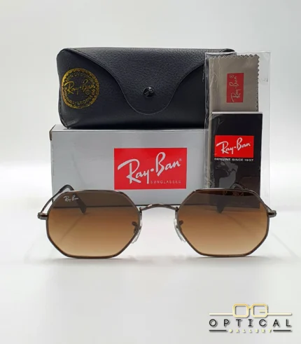 Lunettes de soleil Ray-Ban Octagonal RB3556 marron bronze avec verres dégradés marrons, étui noir, boîte grise et livret Luxottica.