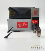 Lunettes de soleil Ray-Ban Octagonal RB3556 marron bronze avec verres dégradés marrons, étui noir, boîte grise et livret Luxottica.