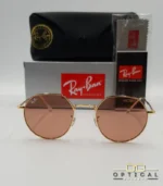 Lunettes de soleil Ray-Ban Jack RB3565 dorées avec verres roses marrons clairs, étui noir, boîte grise et livret de garantie chez Optical Gallery.