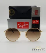 Lunettes de soleil Ray-Ban Jack RB3565 dorées avec verres dégradés marrons, étui noir, boîte grise et livret de garantie chez Optical Gallery.