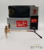 Lunettes de soleil Ray-Ban Jack RB3565 dorées avec verres dégradés marrons, étui noir, boîte grise et livret de garantie chez Optical Gallery.
